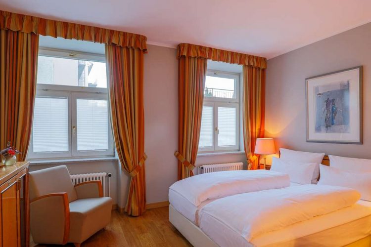 standard double room plus with a wide bed, spacious wardrobe, desk and armchair