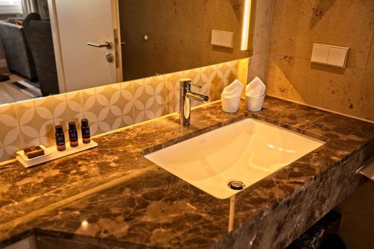 Bathroom with WC, shower, washbasin, make-up mirror and hair dryer